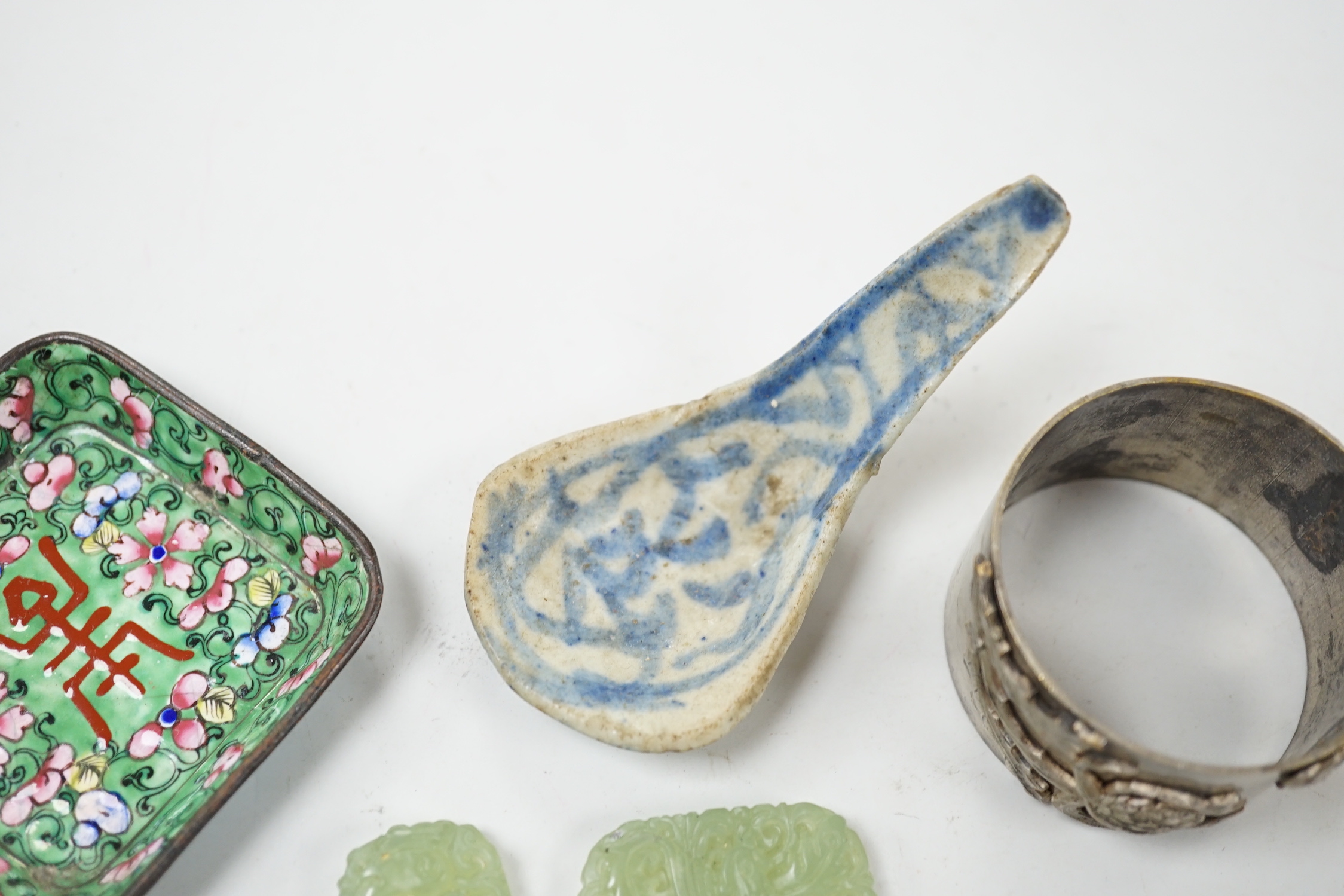 Four Chinese jade items, a pottery spoon, napkin ring and enamel dish, dish 6.5cm wide